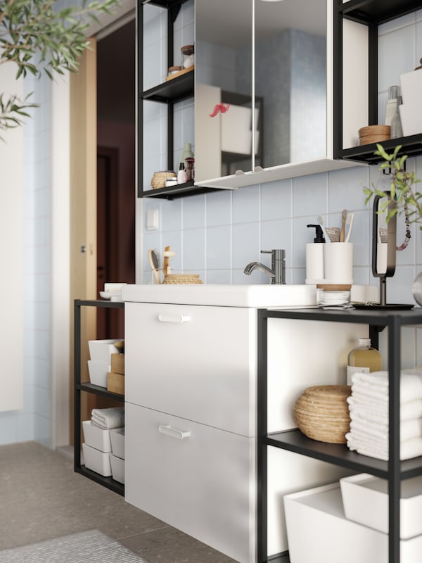 A bathroom wall featuring an ENHET base cabinet for wash-basin with 2 drawers, open frames with shelves and two mirror doors.