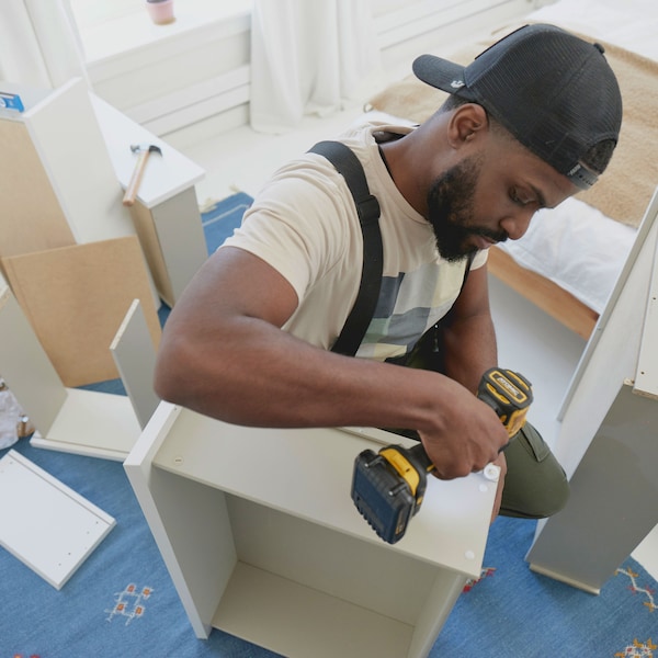 A man working for Taskrabbit assembling furniture