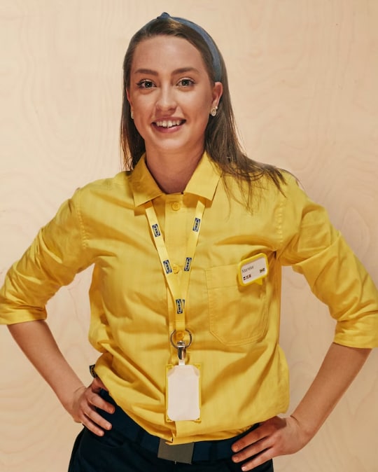 An IKEA co-worker in a yellow shirt. 