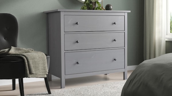 HEMNES chest with 3 drawers standing in a bedroom.