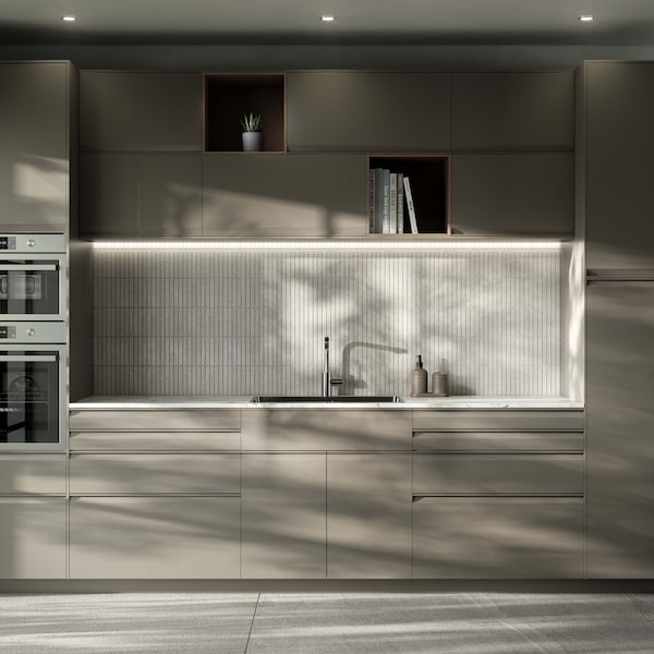 Modern beige kitchen with lght ceramic worktop and integrated handles.