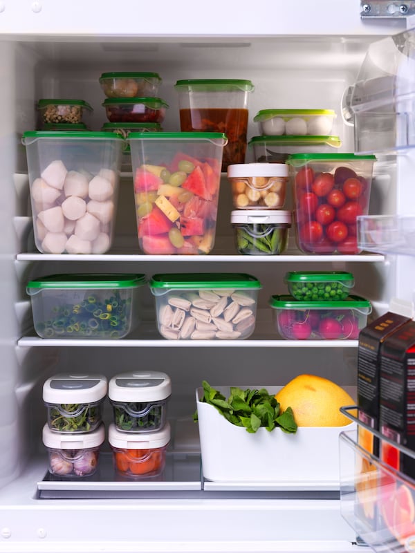 IKEA  PRUTA food containers with green lids in an open fridge 