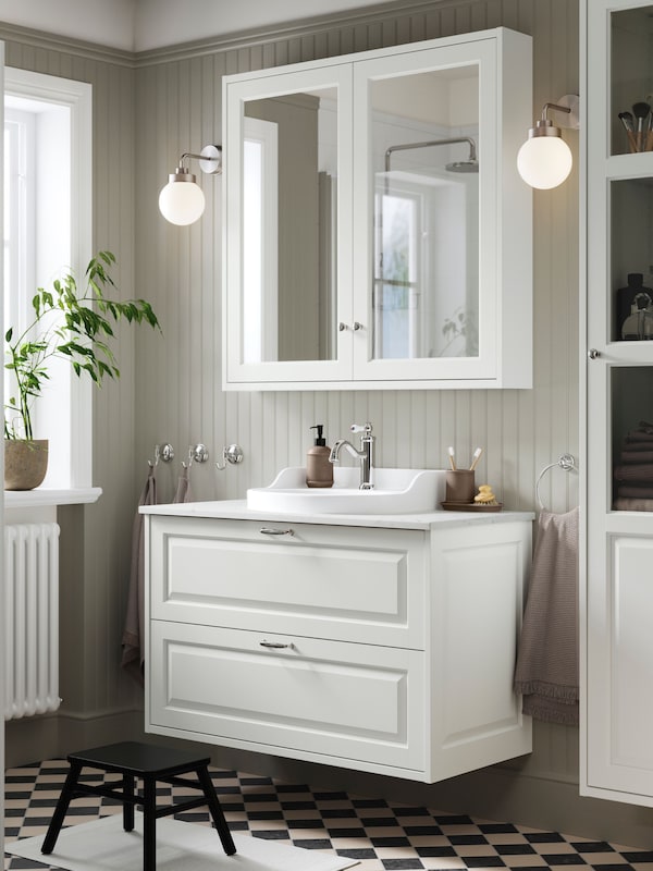 TÄNNFORSEN traditional bathroom sink floating cabinet with white shaker drawer fronts.