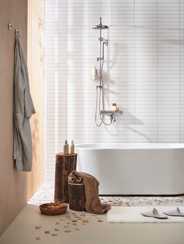 UPPRÄMEN storage basket on an ENHET cabinet next to a bathroom sink and ÖBONÄS caddie stuck to the wall 