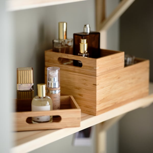 TRENSUM mirror on a shelf next to makeup brushes in an IVRIG glass