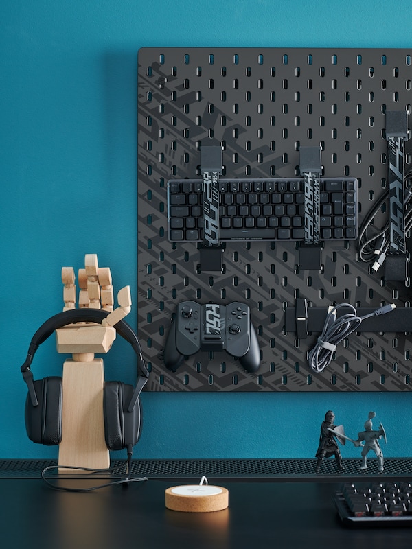 An IKEA UPPSPEL peg board with gaming accessories attached.