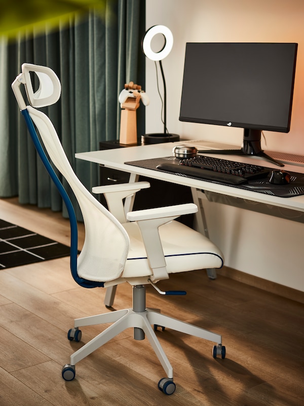 An IKEA MATCHSPEL gaming chair in white in front of a white desk with a computer and keyboard.