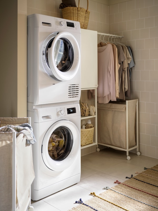 An UDDARP tumble dryer sitting on top of an UDDARP washing machine connected by a TYKARP stacking kit for washer/dryer.