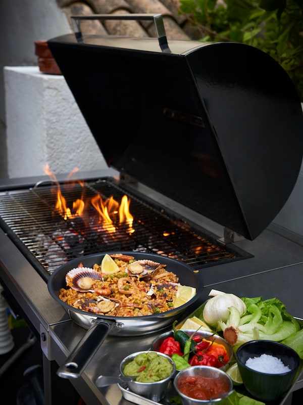 An IKEA 365+ frying pan next to a barbecue lit
