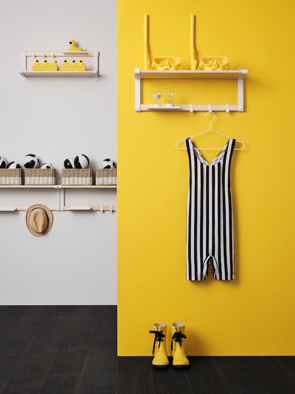 A white/aspen SKOMAKARE wall shelf on a yellow wall in front of a white wall with three SKOMAKARE wall shelves.