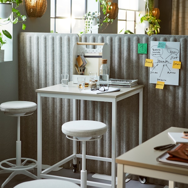 TROTTEN tables and LIDKULLEN active sit-stand supports placed next to a room divider formed by EILIF free-standing screens