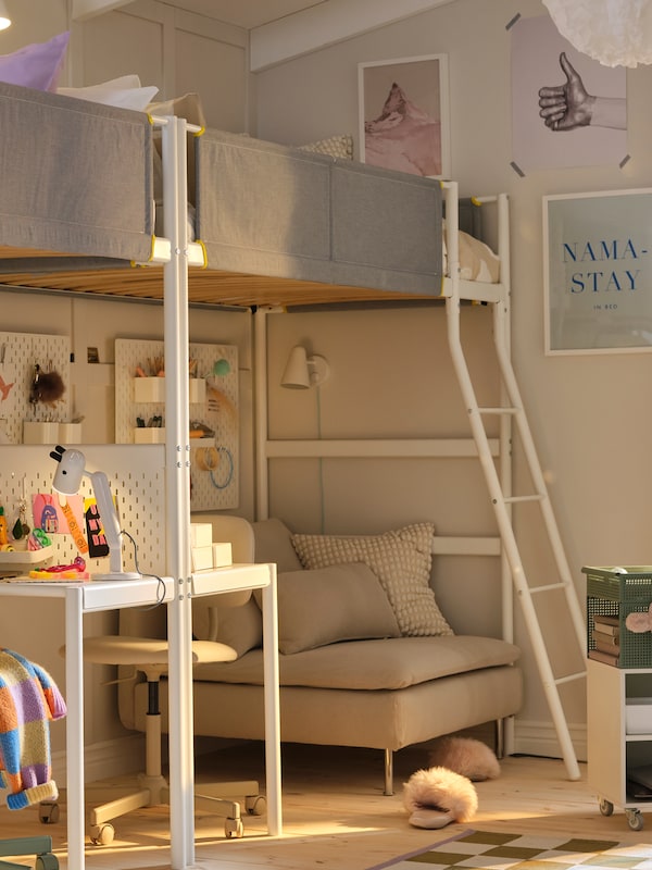 Two VITVAL loft beds and desk top are end-to-end along a beige wall with a beige chair at the desk underneath.